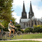 Cycling along the Rhine by the Cologne Cathedral